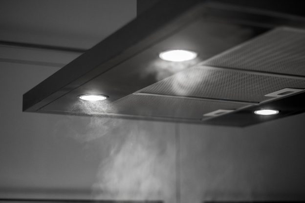 steam under an extraction canopy with lights