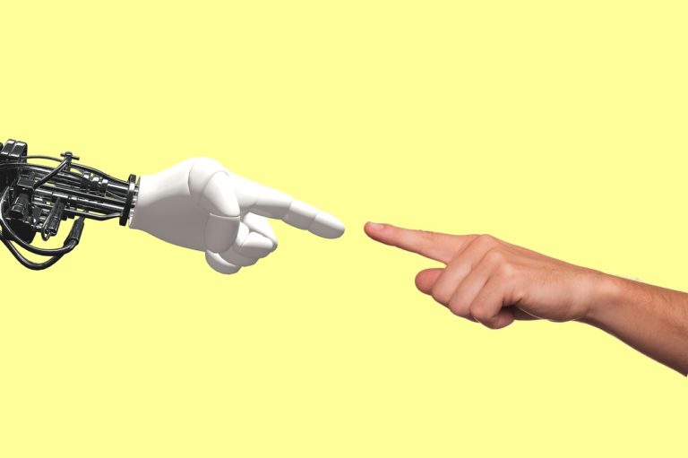 robotic hand with pointed finger touching human hand with pointed finger