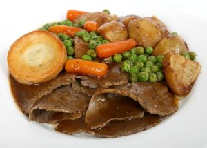 Roast dinner with beef, potatoes, vegetables and Yorkshire pudding