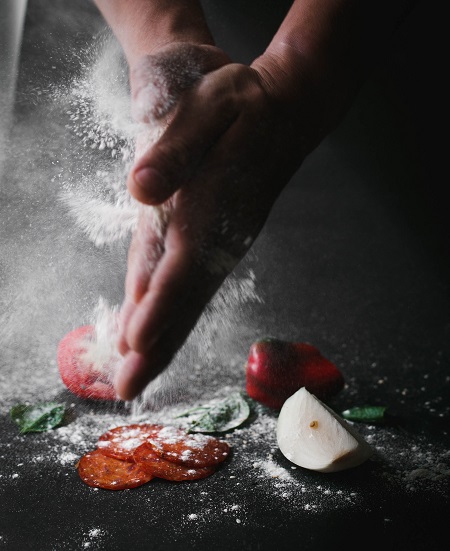 Hands with flour over food ingredients