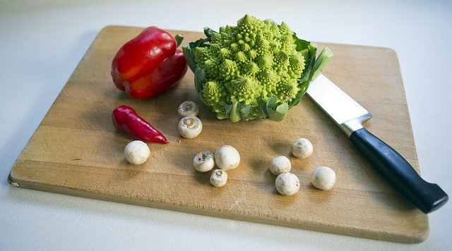 Chopping board with vegetables and chopping knife