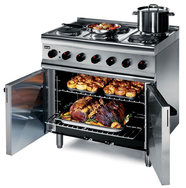 Commercial oven range with saucepans on top hob and food in the oven