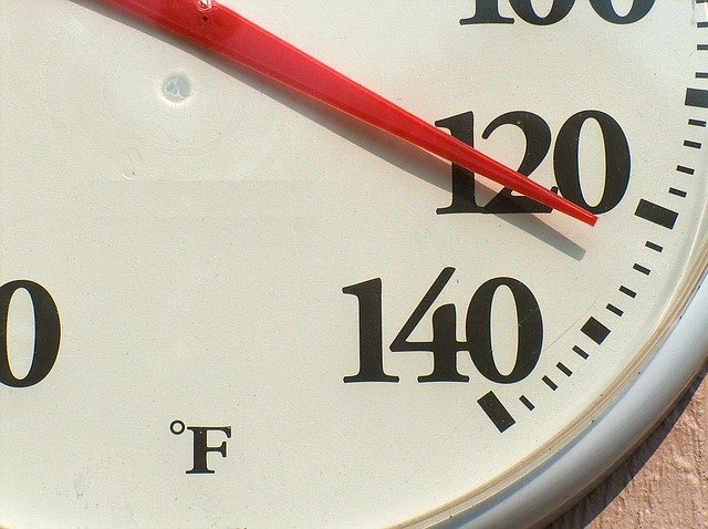 Temperature gauge with red needle pointing to 122