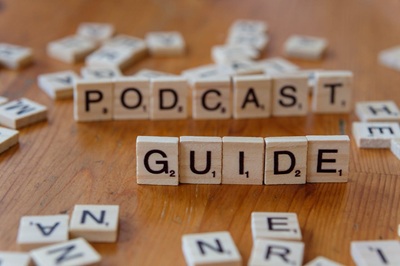 scrabble tiles spelling 'guide' and 'podcast'